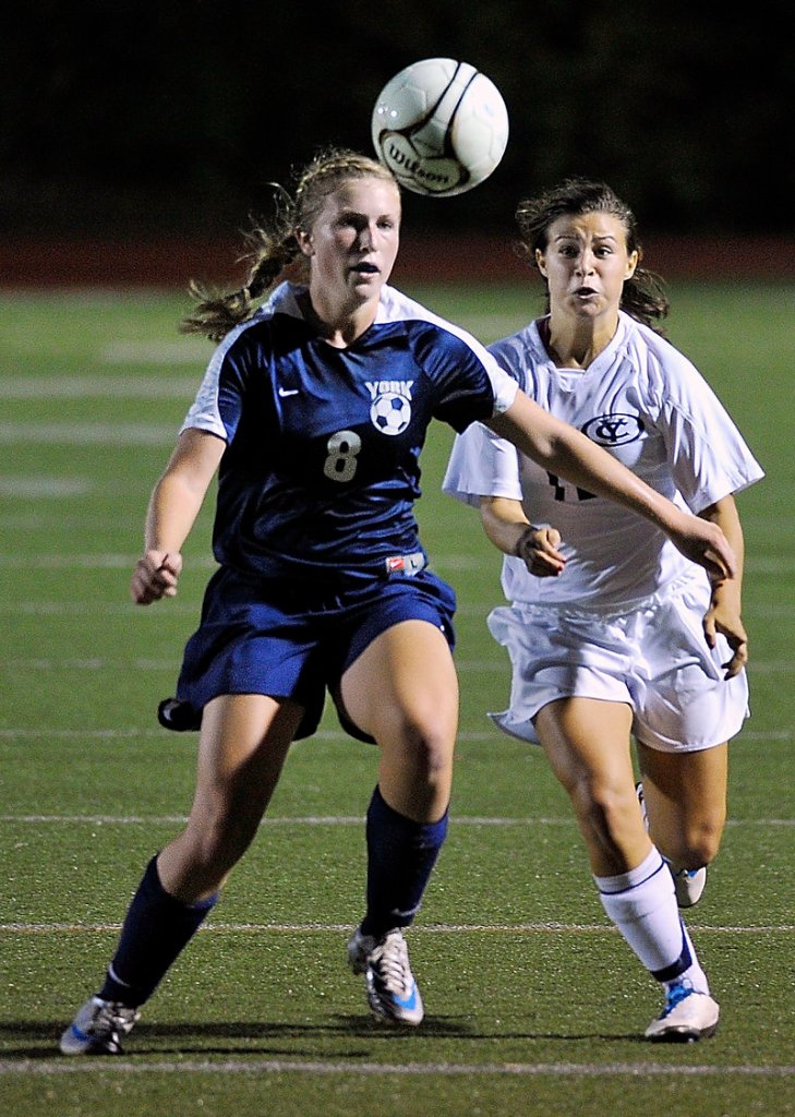 Caitlin Kelly of York attempts to knock the ball away from the charging Jeanna Lowery of Yarmouth near the York goal during the first half of Yarmouth’s 1-0 victory Thursday night.