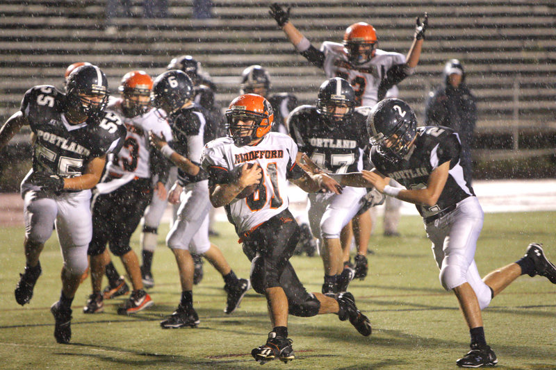 Amid the raindrops at Fitzpatrick Stadium on Friday night, Ryan Webb of Biddeford scurries into the end zone to complete a 31-yard run in the third quarter and give the Tigers a three-touchdown lead against Portland. Biddeford went on to a 35-7 victory.