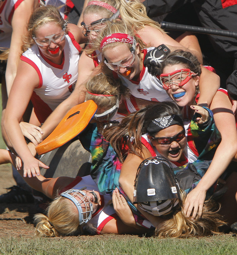 The South Portland field hockey players were a happy group Saturday, piling on top of goalie Lani Edwards after beating Scarborough 2-1 in a Southern Maine Activities Association game. Scarborough hadn't lost in two years.