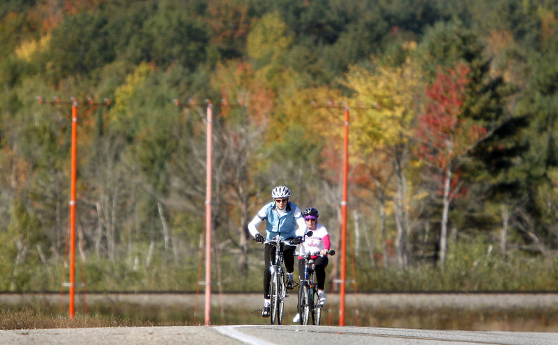 Two cyclists ride up a hill along Kitty Hawk Avenue in Lewiston. The Dempsey Challenge started with a 5K and 10K run and walk Saturday.