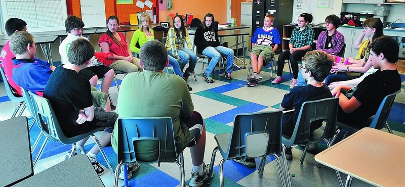 Eighth-graders form a “community circle” to discuss topics and voice opinions at Messalonskee Middle School in Oakland. The circle concept is the cornerstone of a disciplinary approach that requires students to face each other to resolve conflicts.