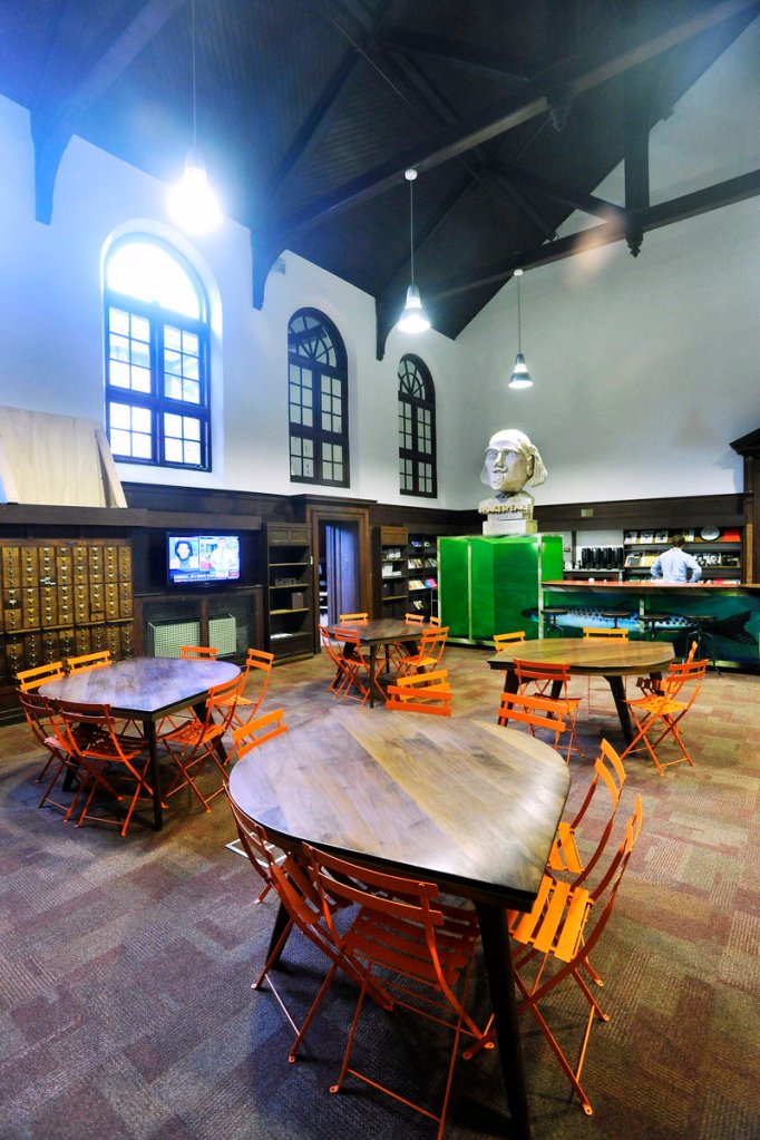 A meeting and lunch area serves as a hub for the advertising and marketing firm. Contemporary furniture is used to accentuate the late-1800s details of the building.