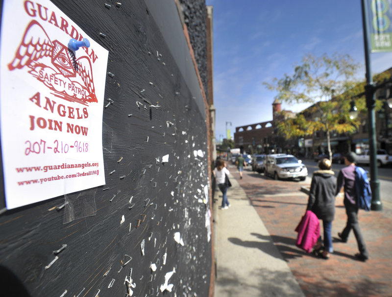 A sign on Congress Street seeks volunteers for a chapter of Guardian Angels now forming up in Portland, organized by a private citizen.