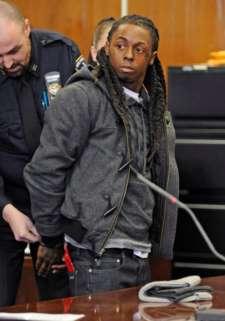 Rapper Lil Wayne is handcuffed at Manhattan criminal court in 2008. He had the best-selling album that year, “Tha Carter III,” and won a Grammy.
