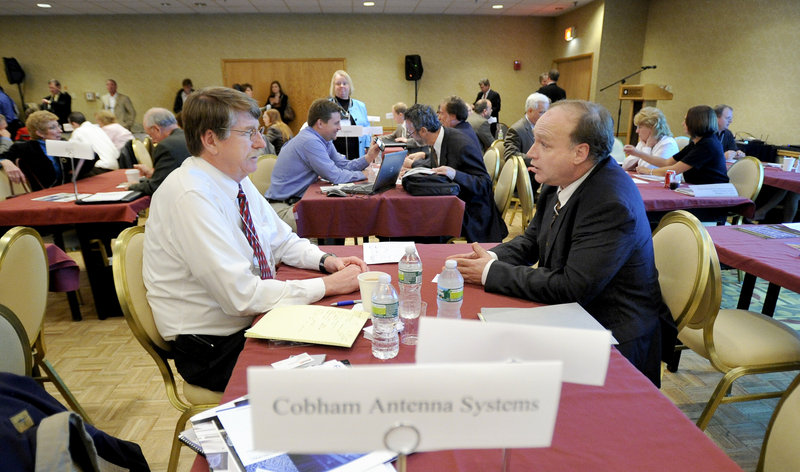 Norm Cheever of Cobham Antenna Systems in Exeter, N.H., talks with Richard Ferrara of Azymuth Telecom and Tailgent in Monmouth at Wednesday’s small business conference at the Wyndham Hotel in South Portland.