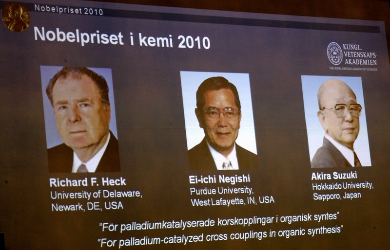 Portraits on an overhead screen in Stockholm, Sweden, show three researchers who won the 2010 Nobel Prize in chemistry on Wednesday. Their work has allowed scientists to make advances in medicine, agriculture and electronics.
