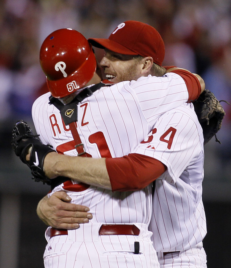 Roy Halladay celebrates with catcher Carlos Ruiz after throwing the second no-hitter in postseason history, a 4-0 win over Cincinnati.