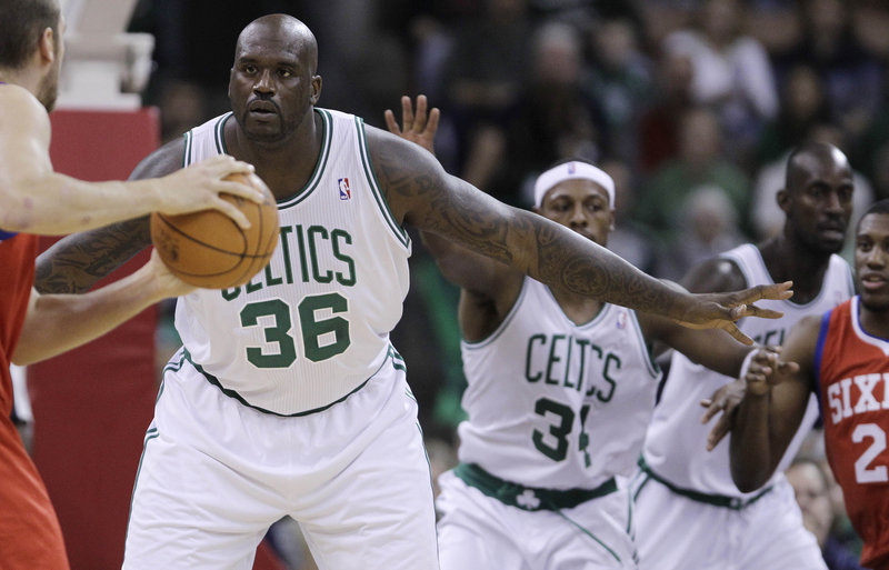 Shaquille O’Neal defends against the Philadelphia 76ers in Manchester, N.H., on Wednesday. It was O’Neal’s debut in a game for the Celtics. He scored eight points in 15 minutes.