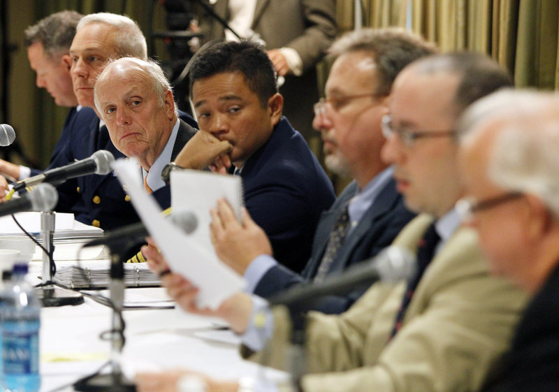 Members of the Gulf oil spill joint investigation board review documents during testimony from BP PLC’s Nick Wilson, not pictured, during hearings held Wednesday by the U.S. Coast Guard and the Bureau of Ocean Management Regulation and Enforcement in Metairie, La.