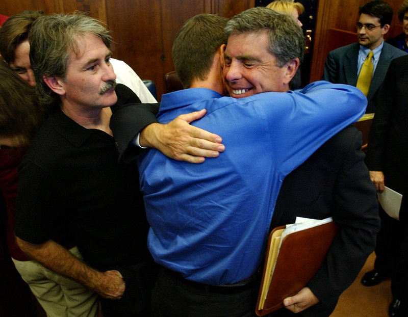 Attorney Robert Sherman, right, is hugged by church abuse victim Gary Bergeron, center, and thanked by victim Bernard McDaid after the Boston Archdiocese agreed to settle clergy sex abuse cases on Sept. 9, 2003. In the wake of the abuse scandal, more churches are doing background checks.