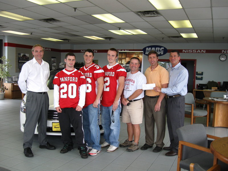 From left are Marc Motors general manager Ed Marshall, SHS football captains Shawn Goodrich, Jon Antara and Justin Carlson, Coach Mike Fallon, Marc Motors service manager Phil Royer and owner Marc Greenberg.