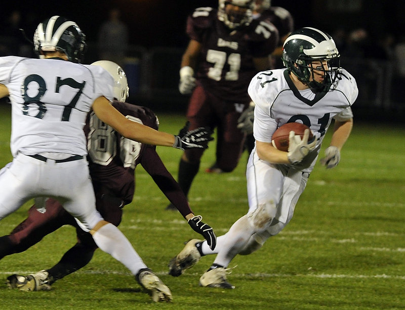 Nick Adkins of Windham gets help from Robert Plaza, left, and breaks into the open during Friday night’s game at Windham. Adkins’ 26-yard run set up the Scots’ final touchdown in a 21-19 victory.