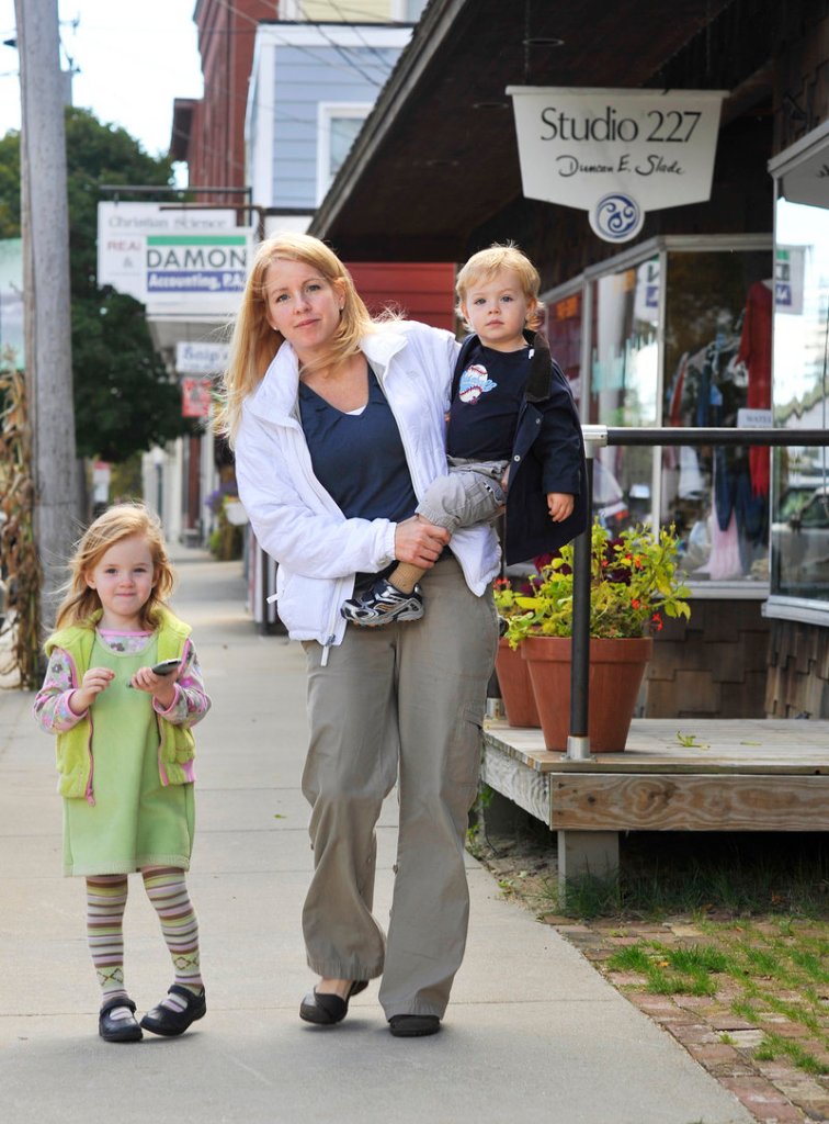 Kerry Hewson, with her children Lauren, 3, and Grady, 2, on Main Street in Norway. Hewson, who moved to town about four months ago from suburban Detroit, believes a casino represents “cheap thrills” and is not right for the area.