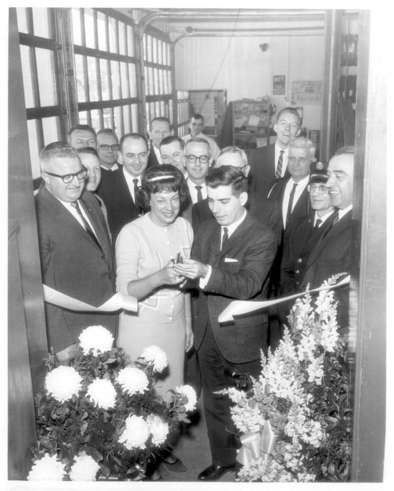 Thomas O. Auger and his wife Mildred mark the grand opening of an L&A Tire store in the early 1960s.