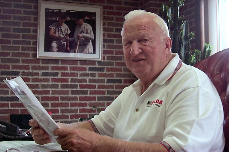 Thomas O. Auger, who died last week, is shown reviewing paperwork in the Lewiston office of his auto parts store, VIP Discount Auto Center, prior to the 2001 sale of the company.