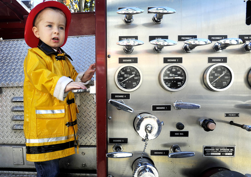 Noah Timmins, 3, of Portland came dressed for the occasion and got to climb aboard a fire truck.