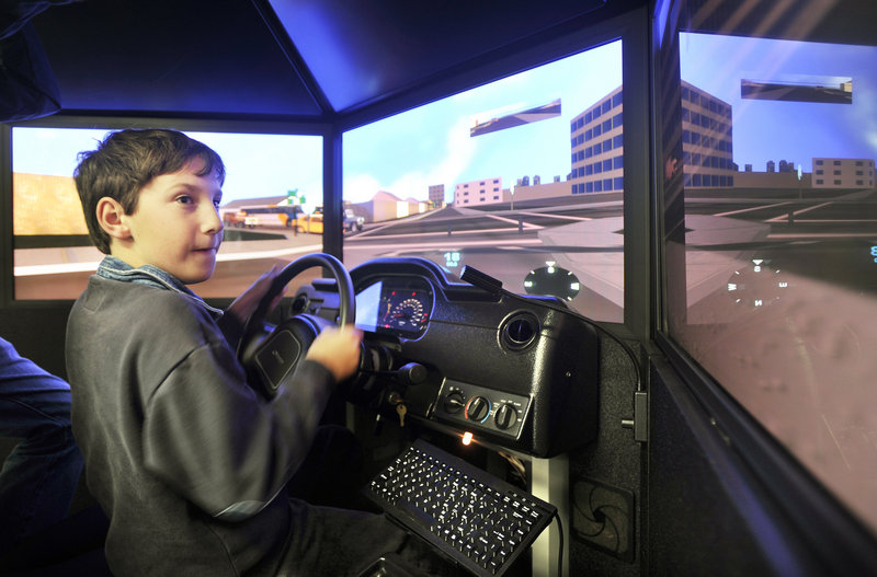 Caleb Cram, 12, of South Portland tries his hand at operating an emergency vehicle driving simulator at the Portland Fire Museum on Spring Street.
