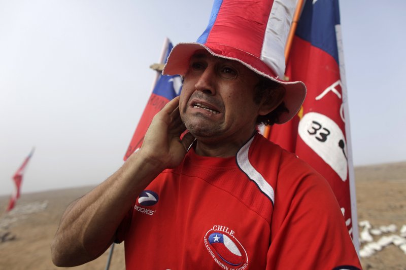 A man weeps after it was announced that a drill reached the 33 trapped miners at the San Jose Mine near Copiapo, Chile, on Saturday, after 33 days of drilling.