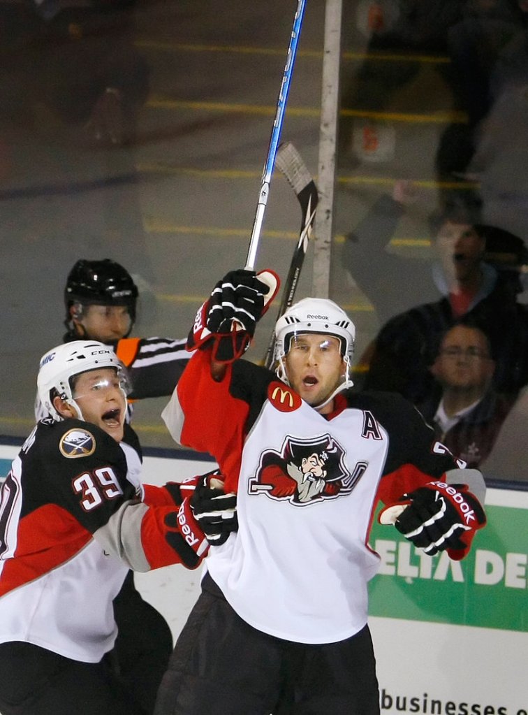 Luke Adam, left, has plenty to celebrate about his start with the Portland Pirates. In Saturday's game, Adam scored twice and added two assists to be named AHL rookie of the week.