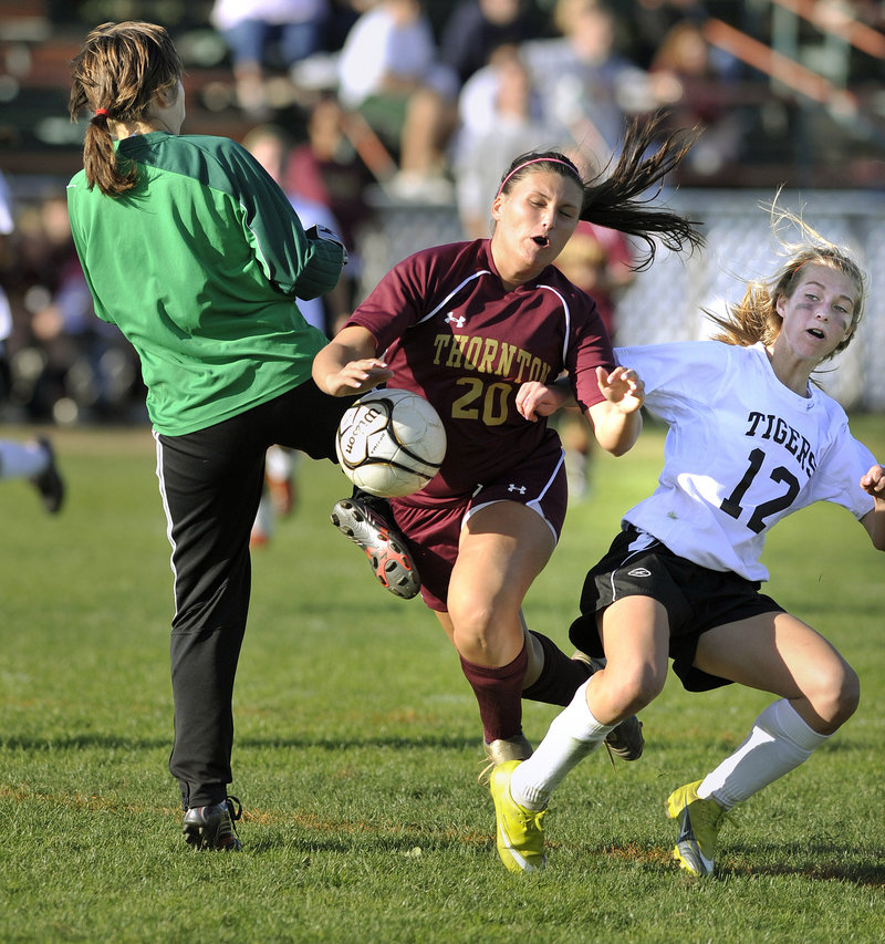 Ashley Kane’s scoring bid for Thornton Academy is broken up by Biddeford goalkeeper Adrienne Bowie, with help from Olivia Jones. Kane was one of five goal scorers for the Trojans in a 5-0 victory.