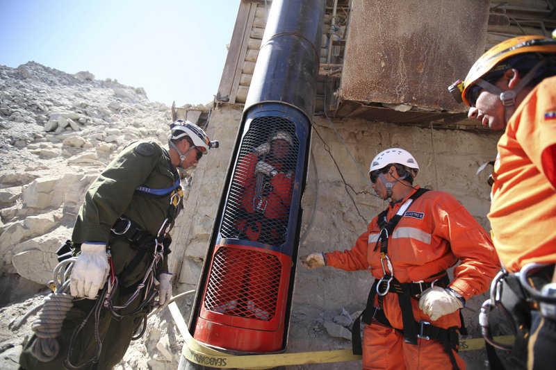 Rescue workers prepare to release a colleague from a capsule after performing a dry run Monday for the eventual rescue of the 33 miners trapped at the San Jose mine near Copiapo, Chile. The rescue apparatus worked flawlessly during four test runs.