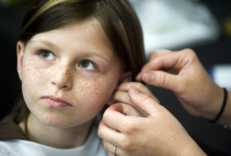 Zahra Clare Baker, 10, is shown in May getting a hearing aid. Police indicated Tuesday that they believe someone killed the 10-year-old North Carolina girl who has bone cancer.