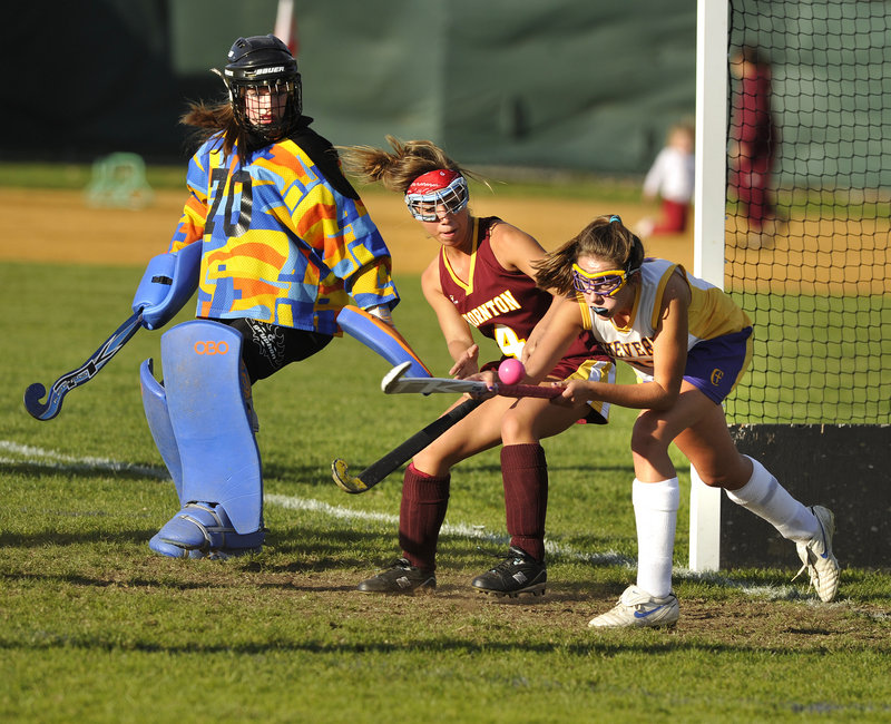 Emily Rodrigue, right, of Cheverus tries to redirect a pass in front of the net while defended by Thornton Academy s Ashley Gaudette and goalie Abbey Siulinski, who made nine saves for her ninth shutout as the Trojans won, 2-0.