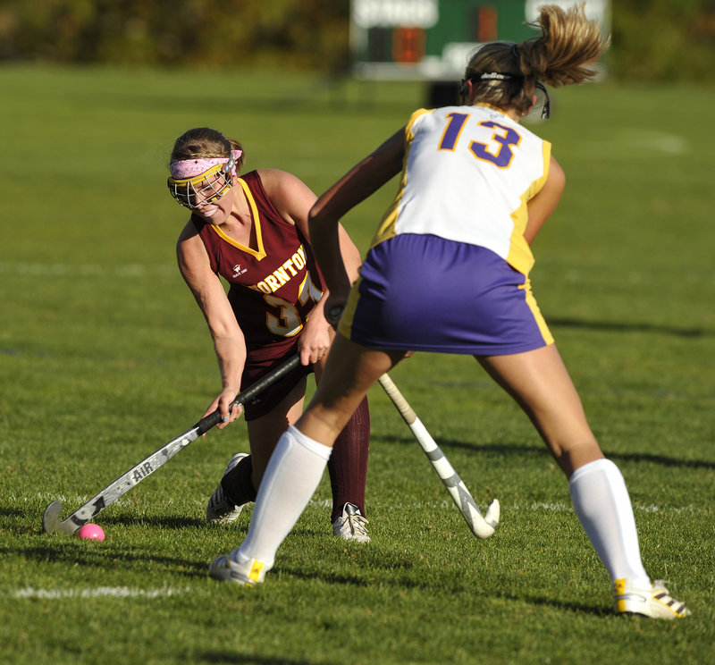 Karen Jacques of Thornton Academy tries to knock the ball past Brooke Flaherty of Cheverus. The Trojans scored a goal in each half.