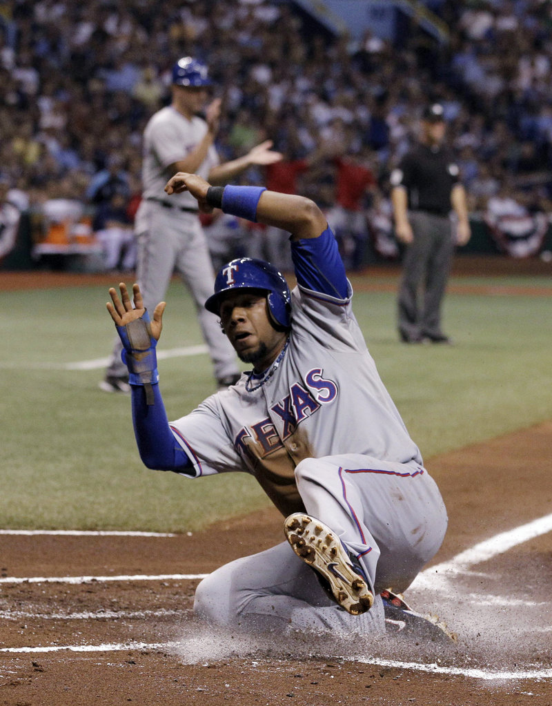 Elvis Andrus of the Texas Rangers scores in the first inning Tuesday night – the start of a 5-1 victory that eliminated the Tampa Bay Rays from the American League playoffs.