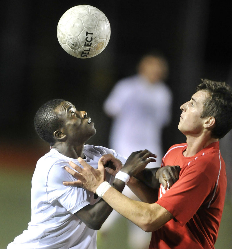 Tony Yekah, left, of Portland and Nemanja Kaurin of South Portland compete for the ball Thursday night during third-ranked Portland s 4-1 victory at Fitzpatrick Stadium.