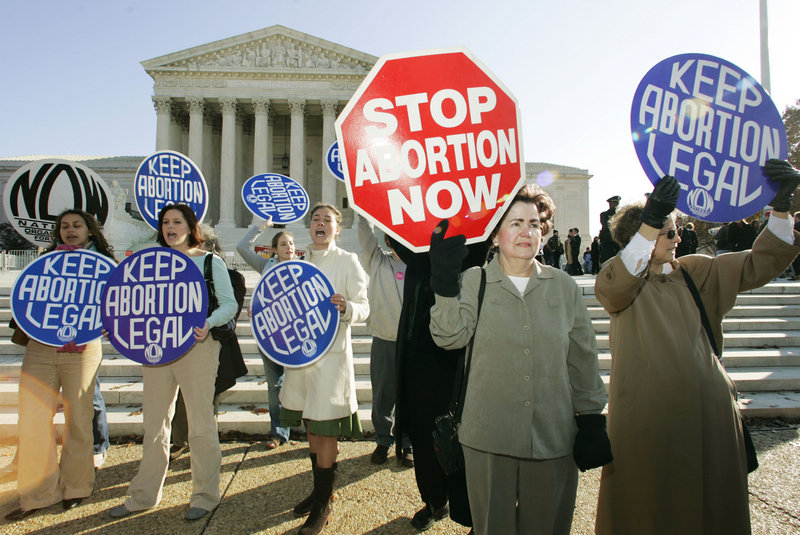 Abortion opponents and proponents stand outside of the U.S. Supreme Court in 2005 during the first abortion case to be decided with John Roberts as chief justice. Both sides of the abortion debate are lining up for a new round of debates, this time over the definition of when fetuses begin to feel pain.