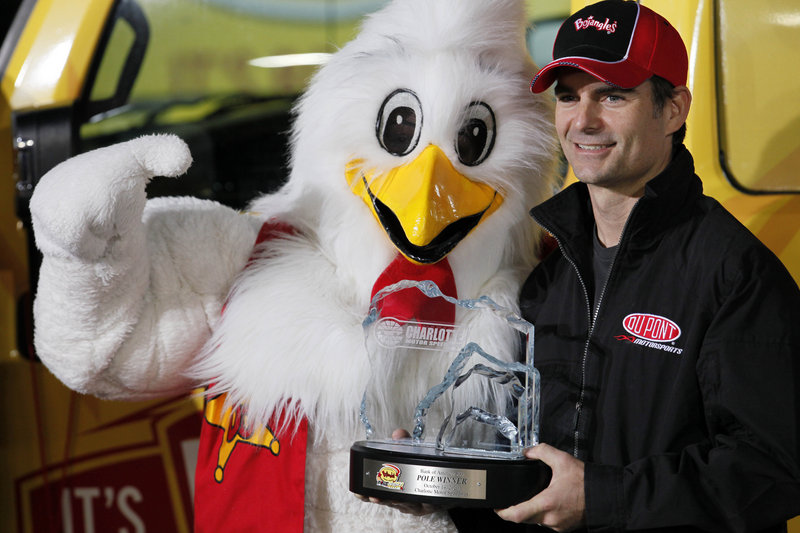 Jeff Gordon poses with the mascot for Bojangles, a Southern restaurant chain, after Gordon took the pole position for tonight’s NASCAR race in North Carolina. Gordon has won five times at the track, but just once since 1999.