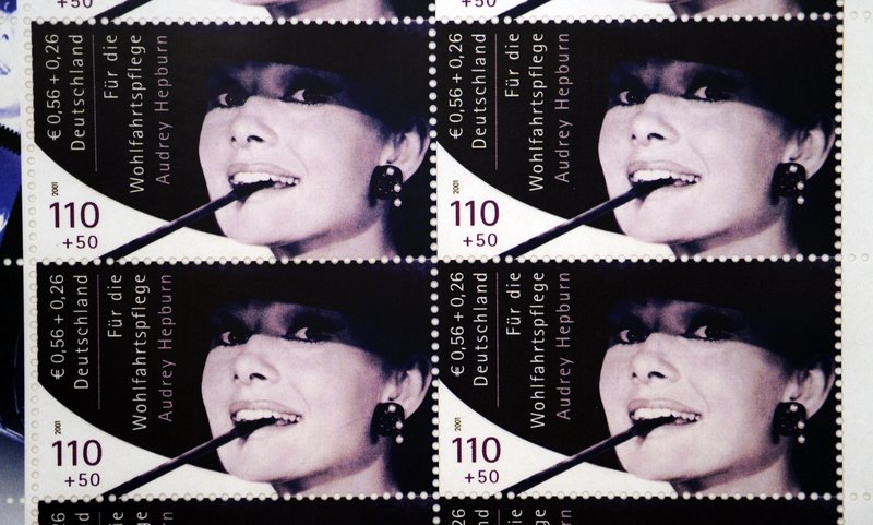 A sheet of 10 Audrey Hepburn stamps that was produced in Germany brings $606,000 in auction.