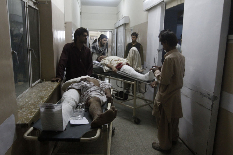The Associated Press Men injured in a blast are brought to a hospital in Kandahar, Afghanistan, on Saturday  one of several attacks in the city.