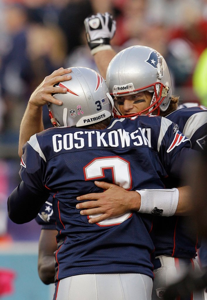 Kicker Stephen Gostkowski and quarterback Tom Brady celebrate Gostkowski’s winning 35-yard field goal in overtime Sunday against the Baltimore Ravens.