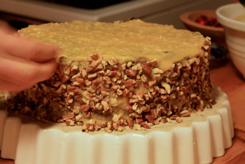 Finishing touch: German chocolate cake gets a coating of toasted pecans.