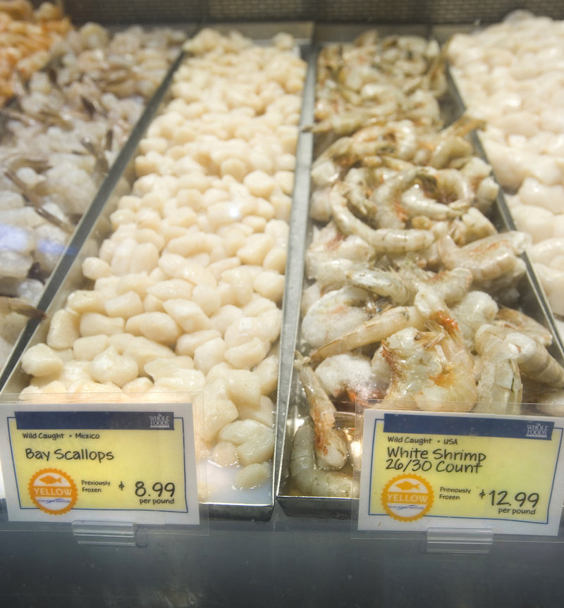 Whole Foods labels on wild-caught bay scallops and white shrimp indicate that they were harvested in Mexico and the USA, respectively, that they were previously frozen, and bear a yellow designation, which suggests some concerns with a fish s status or catch methods.