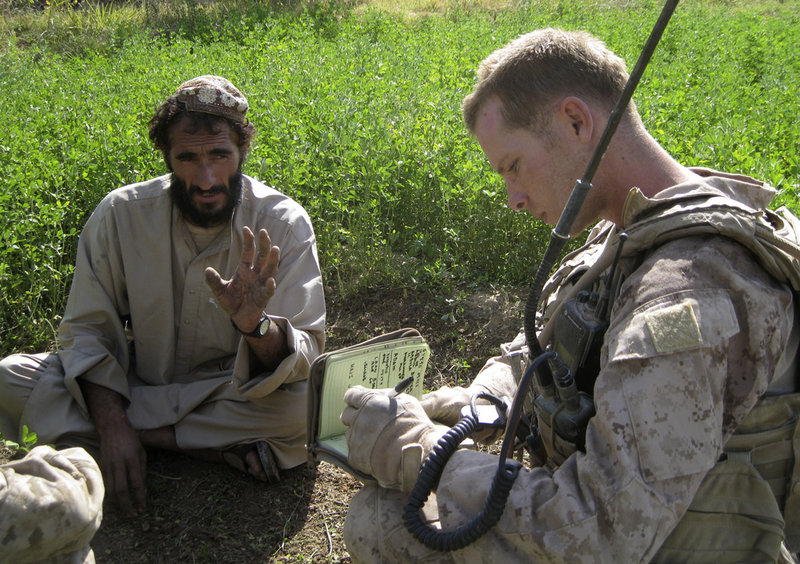 Sgt. John Gabbard talks to a resident of Marjah, Afghanistan, during a patrol. In this southern Afghan town American troops don’t have to go far to find the insurgency. Finding insurgents is another story.