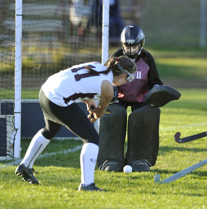 Cape Elizabeth goalie Piper Otterbein stands her ground to stop a scoring bid by Sarah Howard of Greely in the second half.