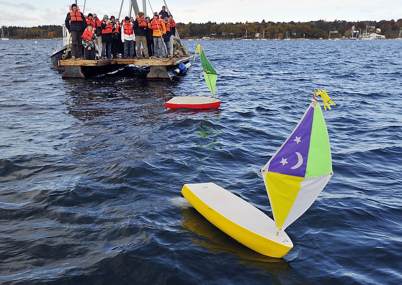 Students from the Compass Project in Gorham test two 5-foot handmade sailboats near Handy Boat in Falmouth on Friday. High school students in the Compass Project's boat-building program are preparing for a trans-Atlantic race of four unmanned, GPS-tracked mini-sailboats, competing against vessels from Belfast, Searsport and Mount Desert Island. The boats will be carried on a freighter leaving Searsport in early November, taken to a location in the Caribbean, then launched into the Gulf Stream. The first boat to get within 100 miles of Europe is the winner.