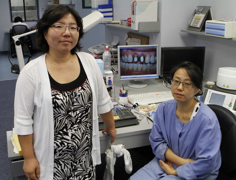 A pair of sisters, Janet, left, and Kay Lee, run a dental laboratory in Los Angeles. They are borrowing $17,000 through the Small Business Administration to pay company debts and hire a part-time technician to make crowns and bridges.
