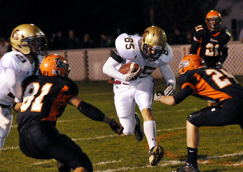 Dmitri Skinsacos of Thornton Academy finds room to run through a hole as the Biddeford defense looks to converge on him.