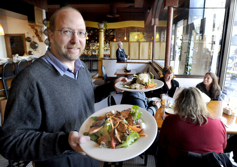 Reporter Ray Routhier has his hands full as he works waiting tables at David's restaurant in Portland.