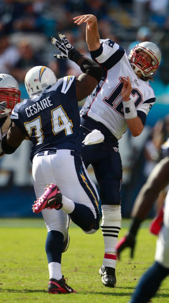 Jacques Cesaire puts pressure on Tom Brady in the second half Sunday. Brady hit 19 of 32 passes for 159 yards and a touchdown.