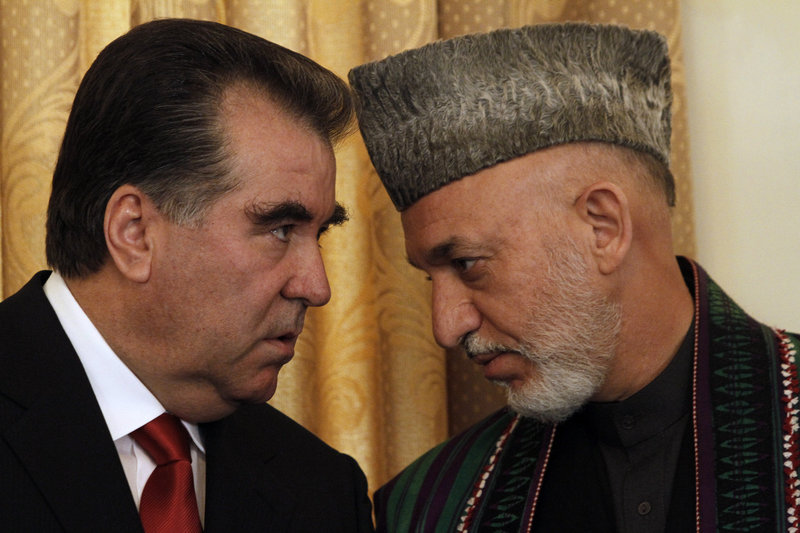 Afghan President Hamid Karzai, right, talks to the President of Tajikistan, Emomalii Rahmon, in Kabul on Monday. Karzai said that once or twice a year Iran gives his office $700,000 to $975,000 for official presidential expenses.