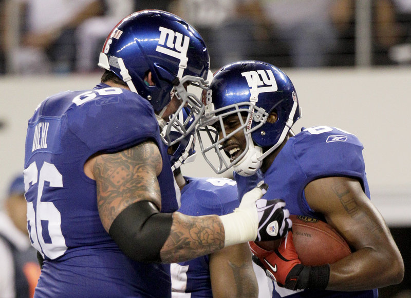 Giants receiver Hakeem Nicks, right, celebrates with lineman David Diehl after one of his two touchdown receptions Monday against the Dallas Cowboys. The Giants overcame an early 20-7 deficit, scoring 31 straight points on the way to a 41-35 win.
