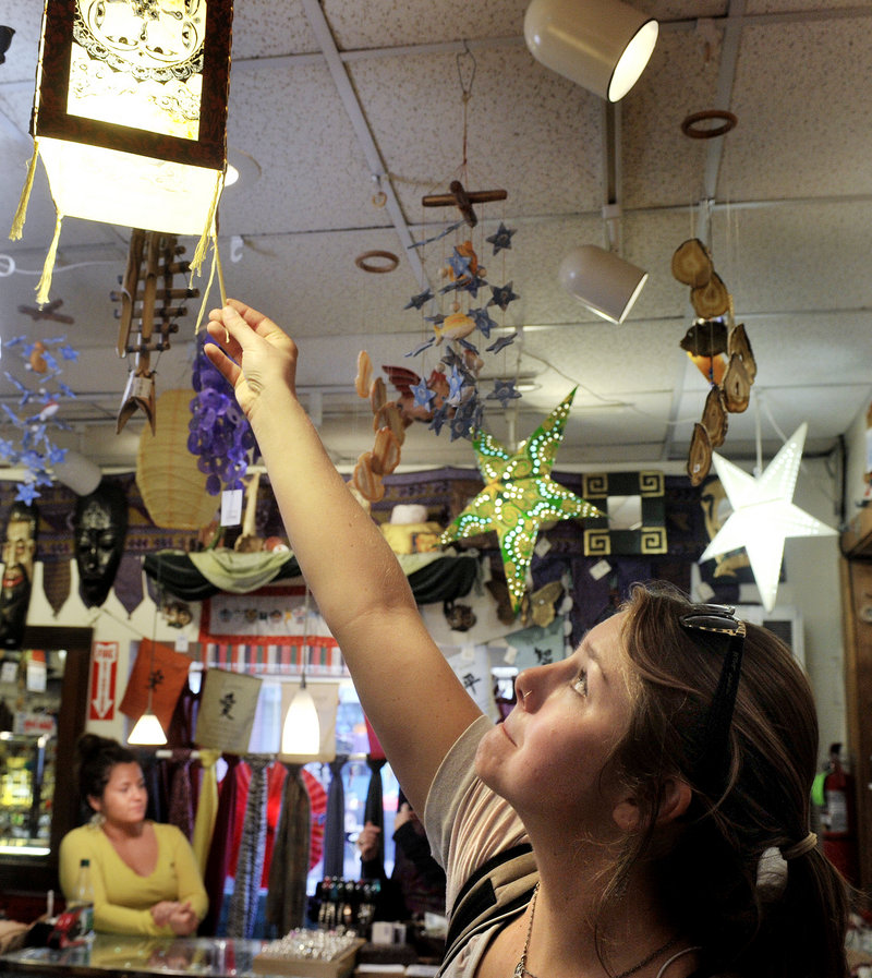 Anne Townsend looks over a selection of lamps for her new Portland apartment while shopping at the Mexicali Blues shop in Portland on Tuesday.