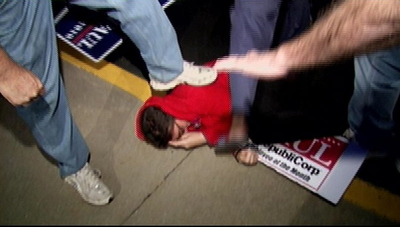 Lauren Valle is stepped on in this image taken from video and released by WDRB of Louisville. Valle was held by supporters of Republican U.S. Senate candidate Rand Paul.