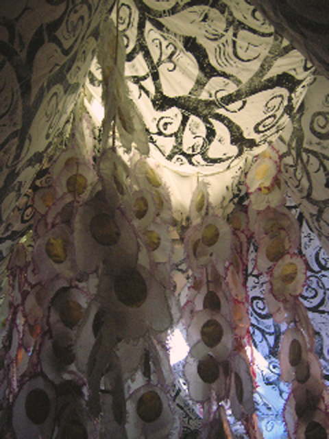 Fabric adorned with ink prints and pod shapes hangs from the ceiling in an installation at the Merrill Memorial Library in Yarmouth as part of the “Majesty of Trees” exhibition.