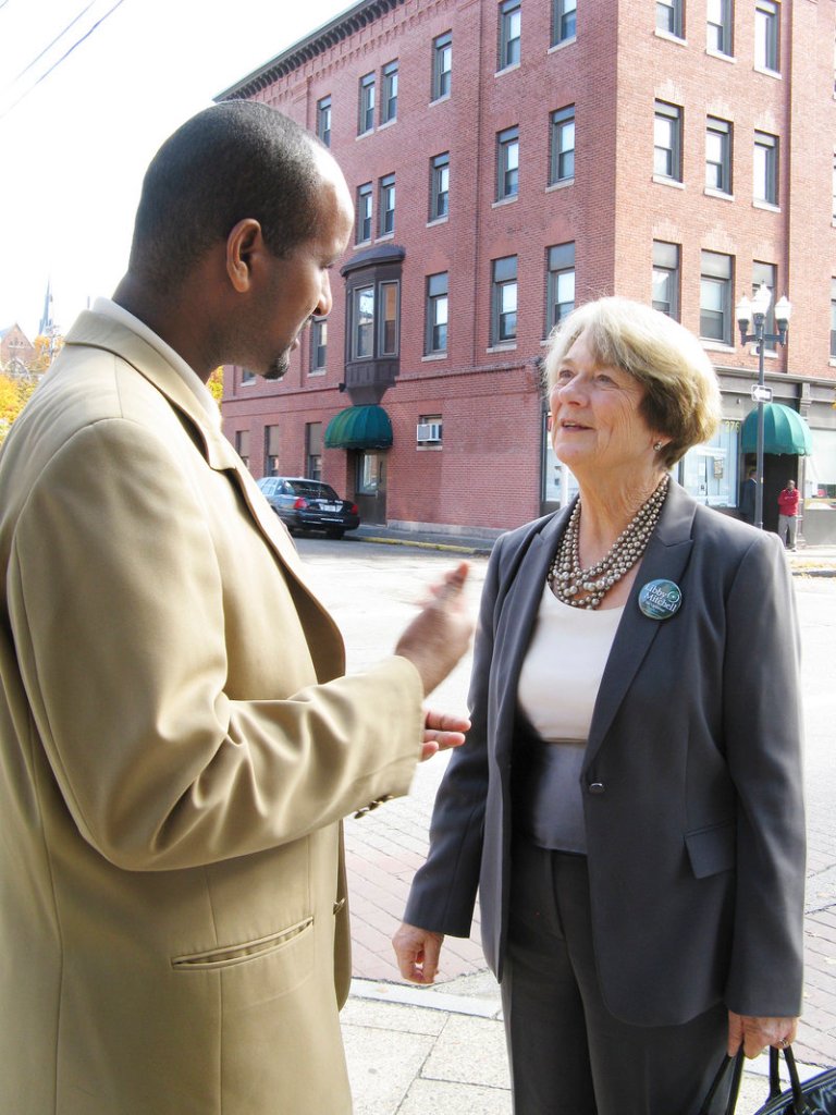 LIbby Mitchell talks with Hussein Ahmed, head of the African Immigrants Association in Lewiston, as her walking tour Thursday visited several Somali-operated shops.